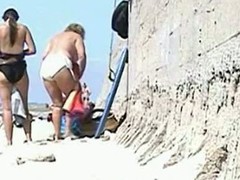 A handful of full-grown women change their garments with the addition of flash those big fat asses with the addition of saggy tits to a hidden beach voyeur who records it circa on tape